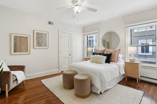 bedroom with visible vents, ceiling fan, baseboards, ornamental molding, and wood finished floors