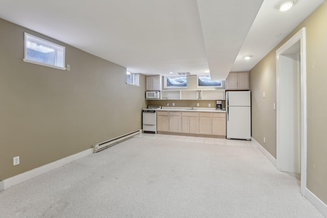 kitchen featuring white appliances, a sink, light countertops, light colored carpet, and baseboard heating