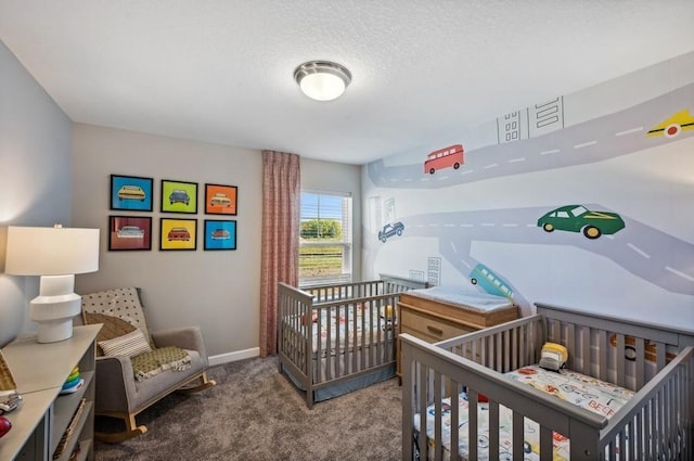 carpeted bedroom with baseboards, a nursery area, and a textured ceiling