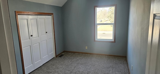 unfurnished bedroom featuring multiple windows, baseboards, and dark colored carpet