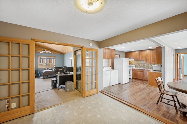 kitchen with washer and dryer, tasteful backsplash, french doors, white appliances, and brown cabinetry