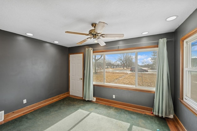 spare room with recessed lighting, ceiling fan, a textured ceiling, and baseboards