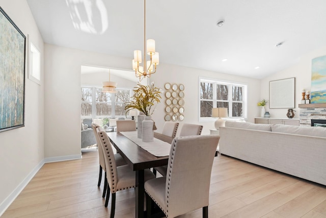 dining area with baseboards, a chandelier, light wood-type flooring, lofted ceiling, and recessed lighting