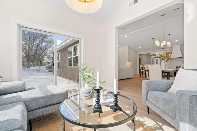 living room featuring a chandelier, visible vents, light wood-style flooring, and recessed lighting