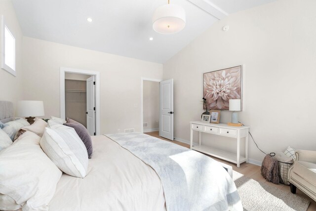 bedroom with recessed lighting, light wood-style flooring, baseboards, and vaulted ceiling