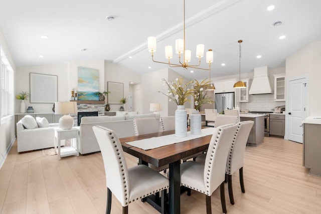 dining room featuring recessed lighting, light wood finished floors, a notable chandelier, and vaulted ceiling