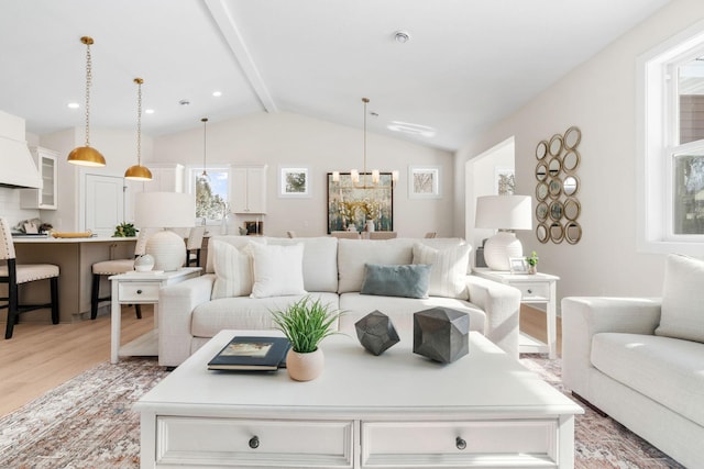 living area with light wood-style floors, vaulted ceiling with beams, and recessed lighting