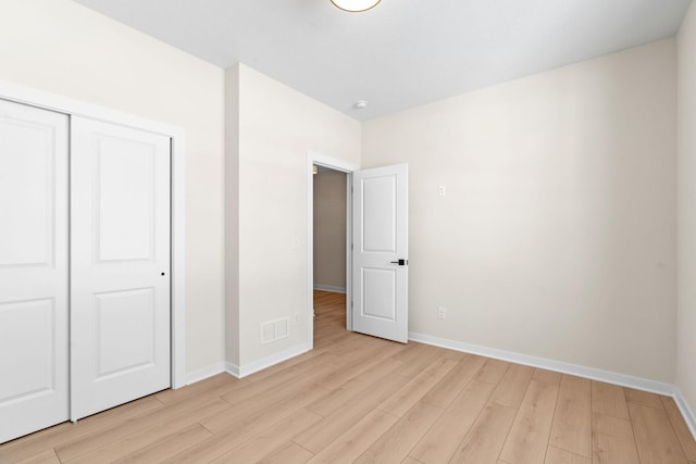unfurnished bedroom featuring light wood finished floors and baseboards
