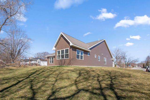 view of side of home with a yard