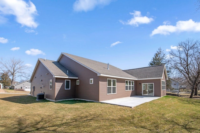 back of property with cooling unit, roof with shingles, a yard, and a patio area