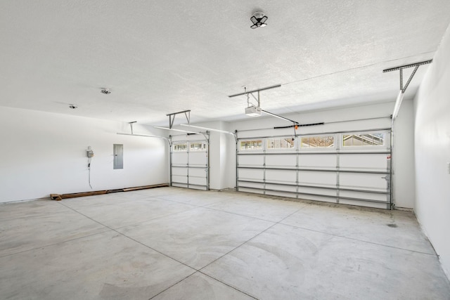 garage featuring a garage door opener and electric panel
