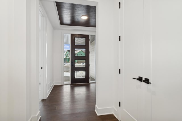 foyer entrance featuring dark wood-style floors and baseboards