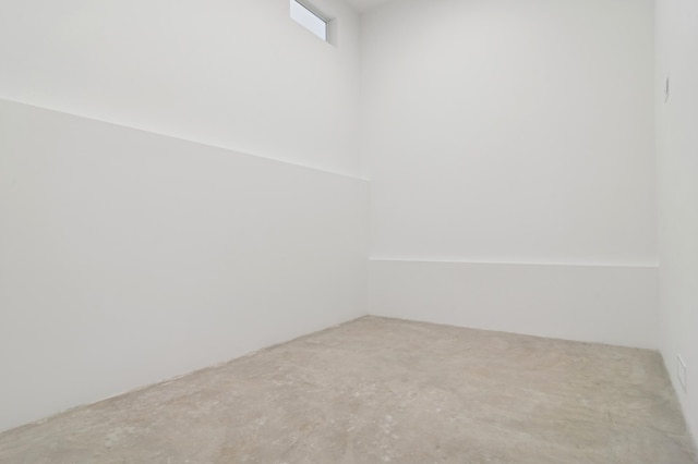 unfurnished room with unfinished concrete floors