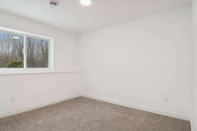 empty room with carpet flooring and baseboards