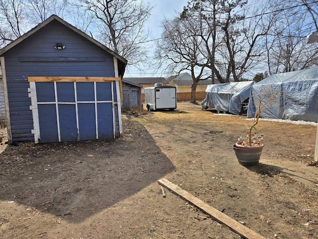 view of yard with a storage shed and an outdoor structure