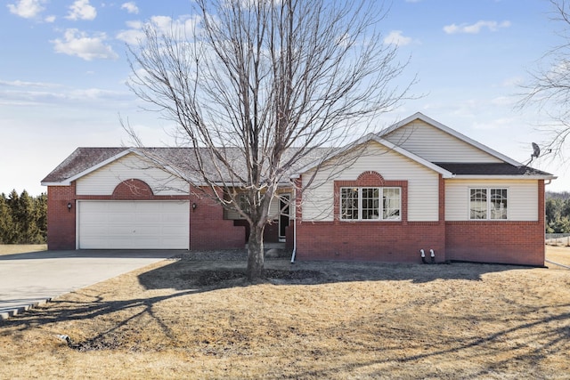 single story home with brick siding, driveway, and a garage