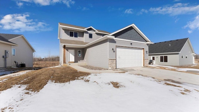 view of front facade featuring central AC, an attached garage, stone siding, and driveway