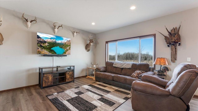 living area featuring recessed lighting, wood finished floors, and baseboards