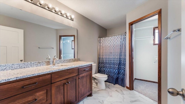 full bath with baseboards, toilet, vanity, marble finish floor, and a textured ceiling