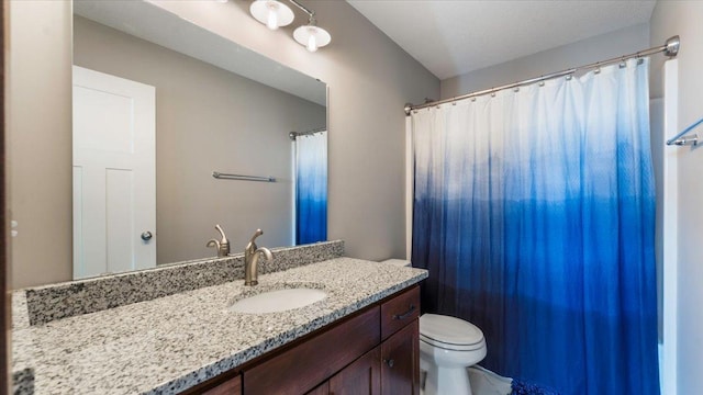 bathroom featuring vanity, a shower with shower curtain, and toilet