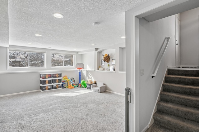 playroom featuring recessed lighting, a textured ceiling, baseboards, and carpet floors