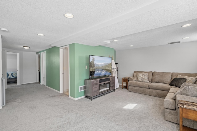 living area with visible vents, carpet flooring, and baseboards