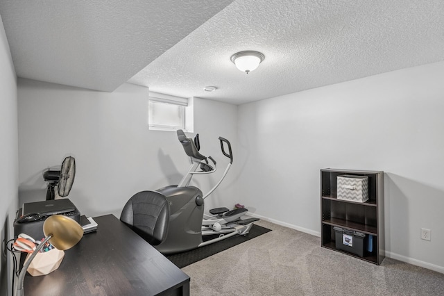 office space featuring baseboards, carpet floors, and a textured ceiling