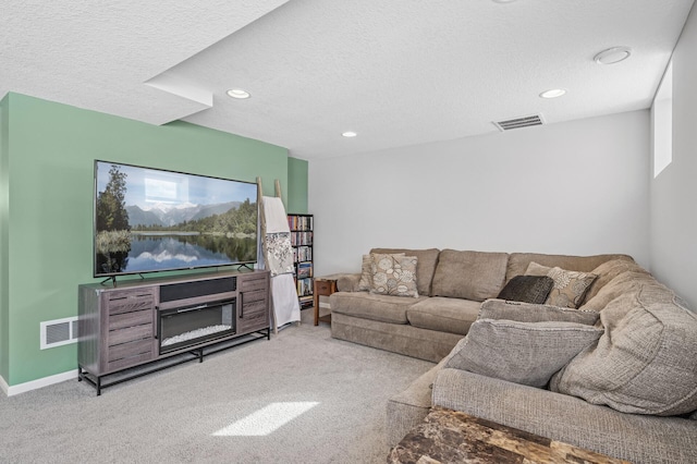 living area featuring visible vents, carpet floors, a textured ceiling, and baseboards