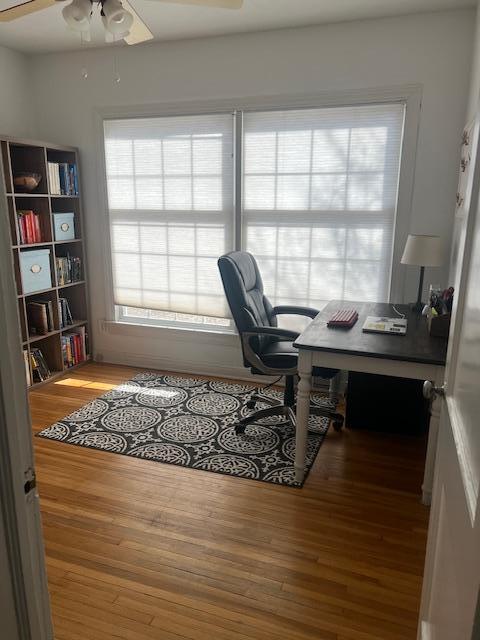 home office with wood finished floors and ceiling fan