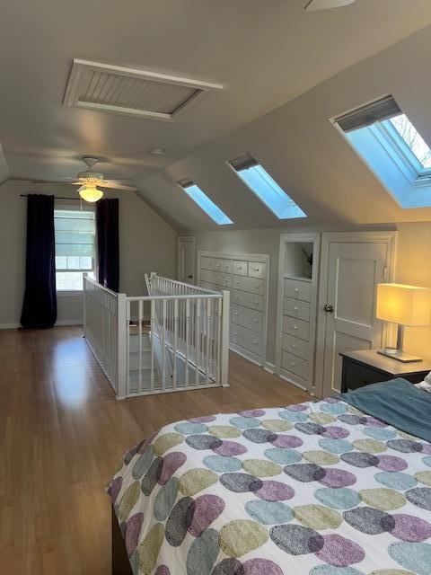 bedroom with lofted ceiling and wood finished floors