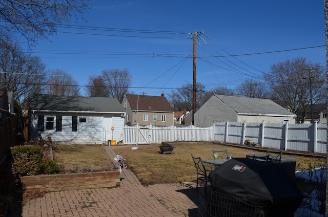 view of yard with a patio, a fenced backyard, and a fire pit