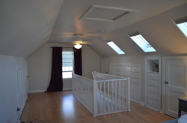 bonus room featuring vaulted ceiling, wood finished floors, and visible vents