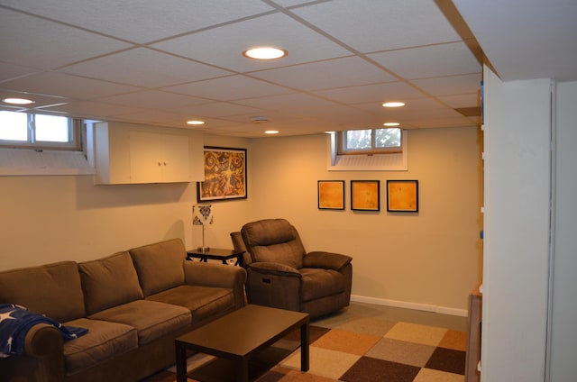 living room with recessed lighting, a paneled ceiling, and baseboards