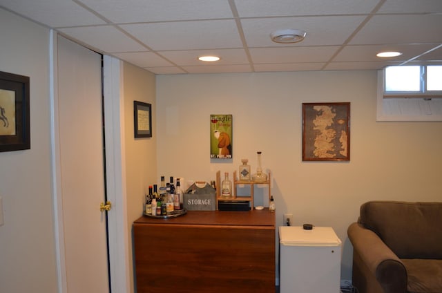 home office featuring recessed lighting, a paneled ceiling, and a bar