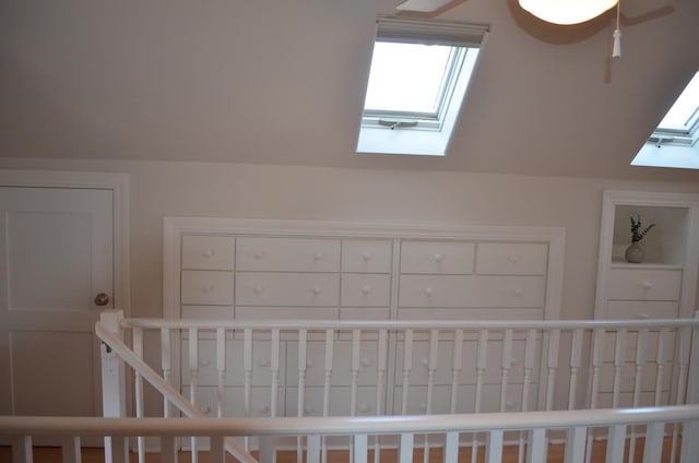 additional living space with vaulted ceiling with skylight