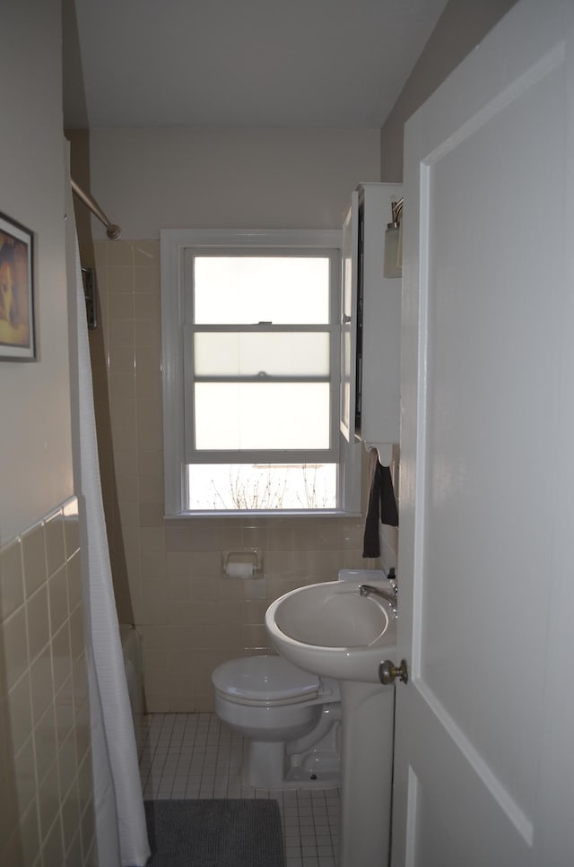 bathroom featuring tile patterned floors, toilet, tile walls, and a shower with shower curtain