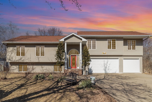 raised ranch with a garage and driveway