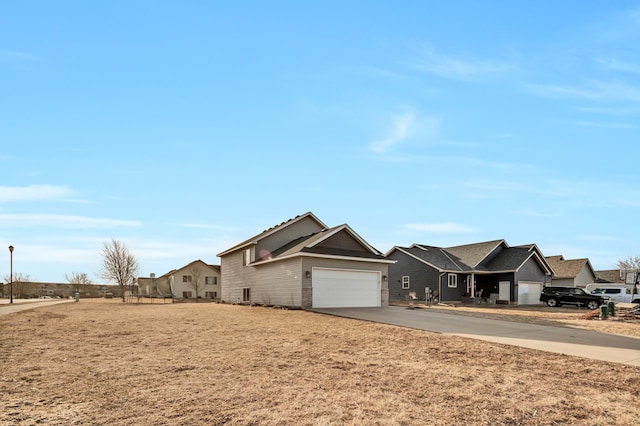 ranch-style home featuring concrete driveway and an attached garage