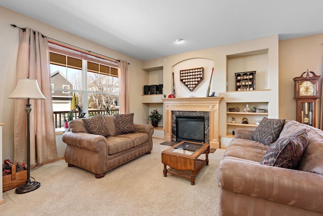 carpeted living area with built in shelves and a fireplace