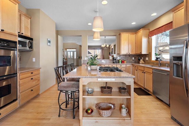 kitchen featuring tasteful backsplash, light brown cabinets, open shelves, appliances with stainless steel finishes, and a sink