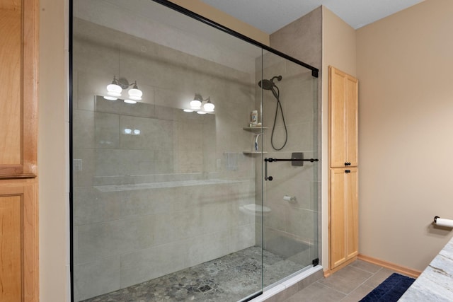 full bathroom featuring tile patterned floors and a stall shower