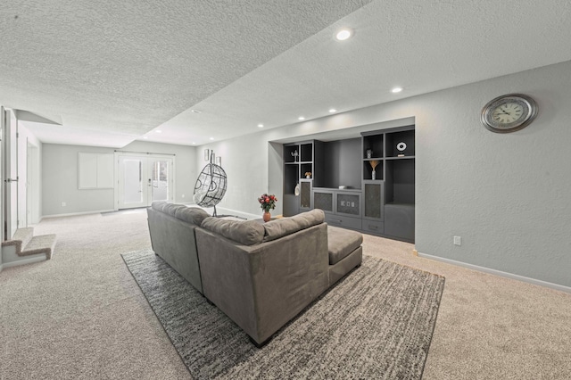 carpeted living room featuring recessed lighting, a textured wall, baseboards, and a textured ceiling