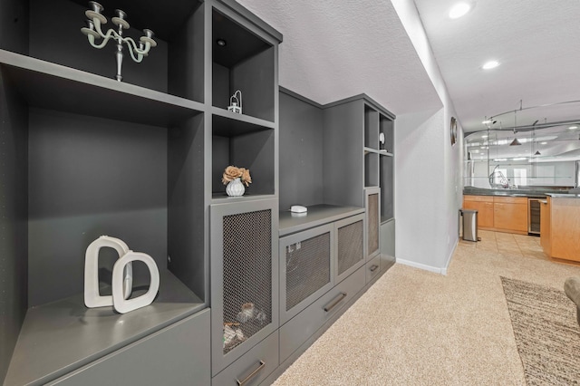 interior space with recessed lighting, baseboards, and beverage cooler