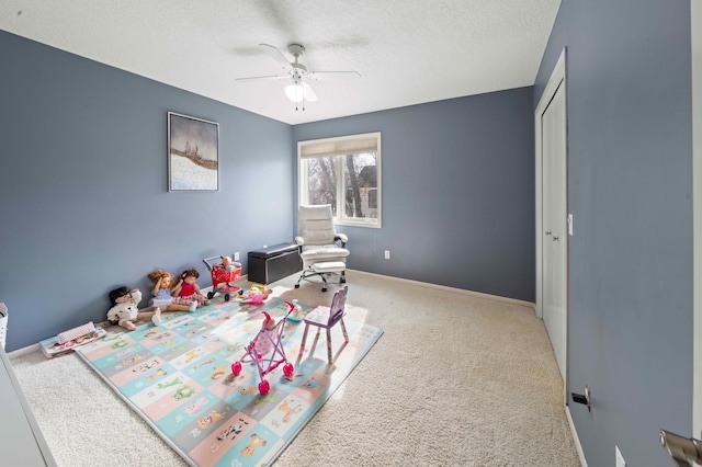 carpeted bedroom with a ceiling fan, baseboards, a closet, and a textured ceiling