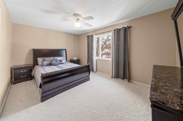 carpeted bedroom featuring baseboards, a textured ceiling, and a ceiling fan