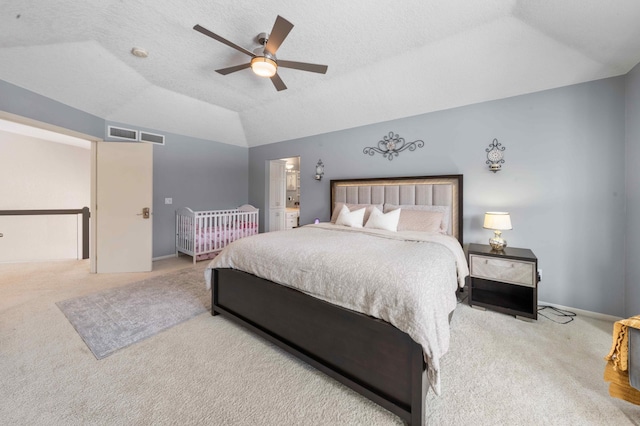 carpeted bedroom with visible vents, baseboards, lofted ceiling, a textured ceiling, and a ceiling fan