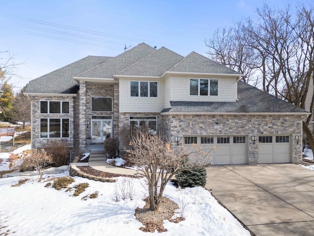 view of front facade featuring stone siding, concrete driveway, and roof with shingles