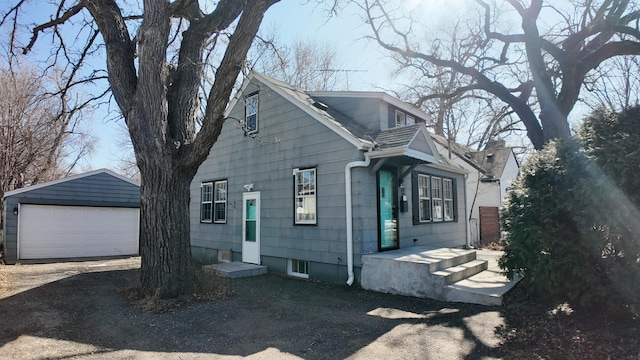 view of front of property featuring an outbuilding and a garage