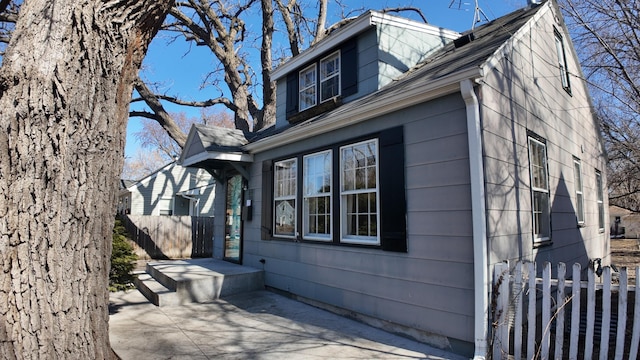 view of side of property featuring a patio area and fence