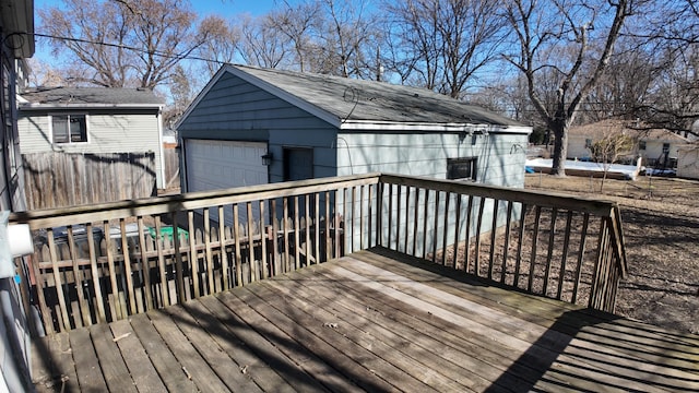 wooden terrace featuring an outbuilding and a detached garage